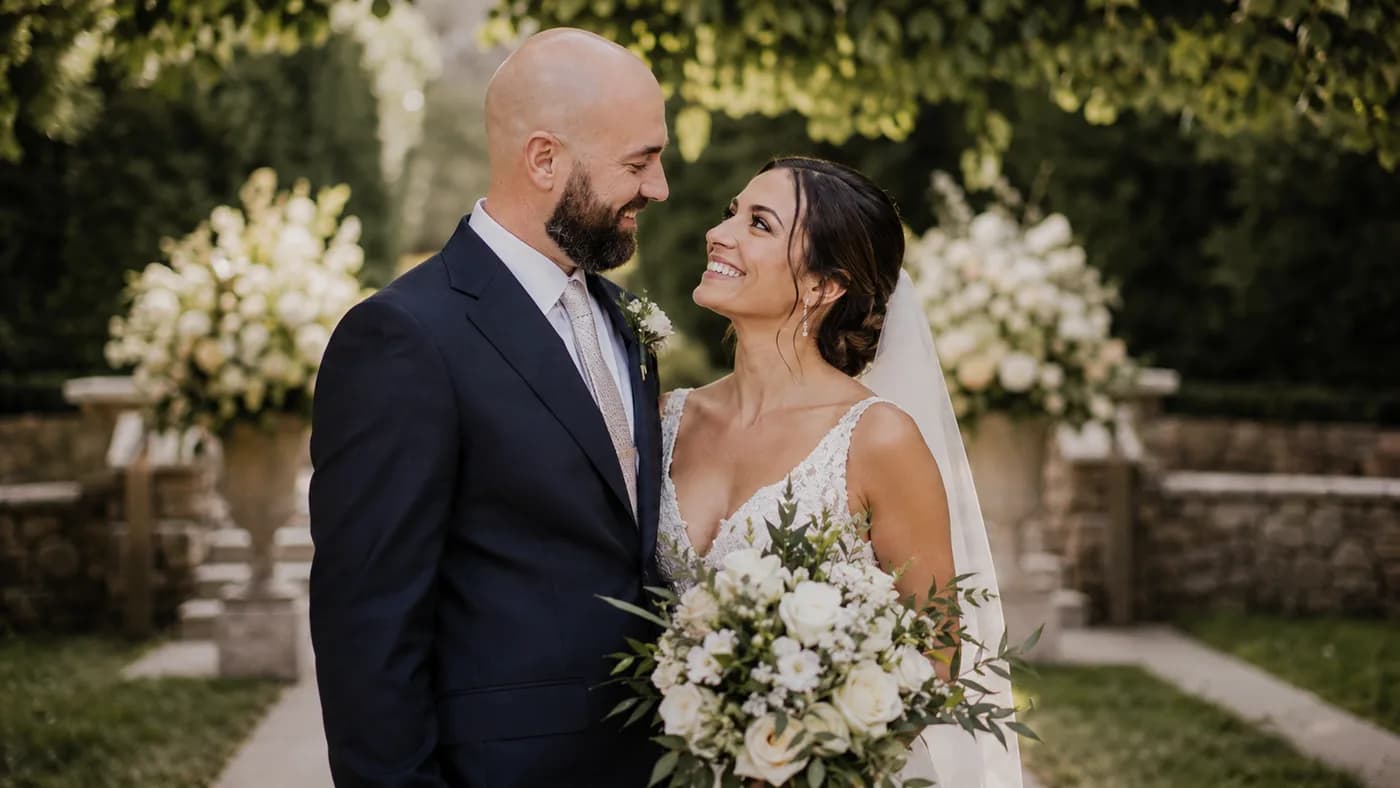 Bald groom photographed in soft outdoor wedding light